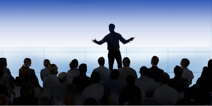 Male presenting confidently on stage